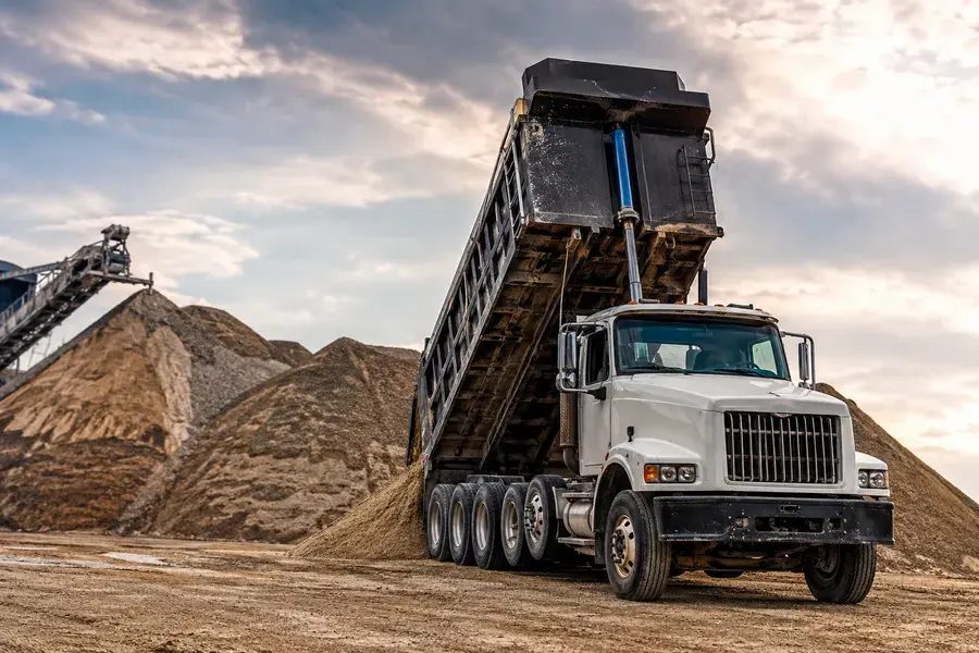 Dump truck hauling sand and gravel
